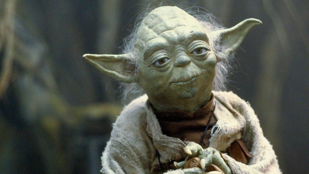 Yoda standing looking bored in Star Wars