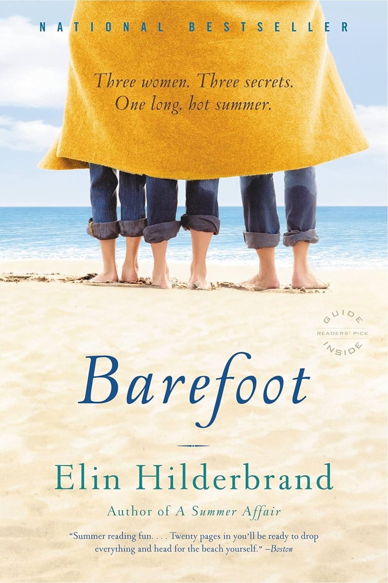 three barefoot women standing on a beach