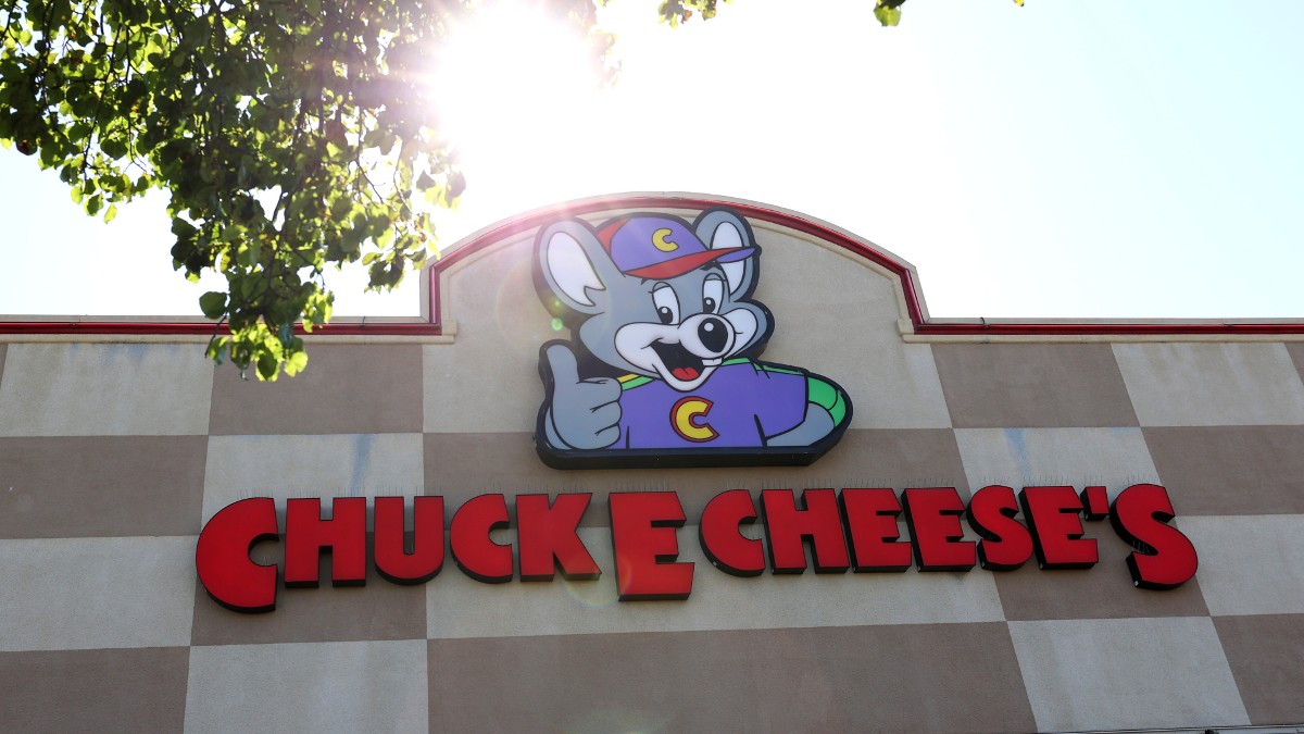 A Chuck E Cheese sign and logo
