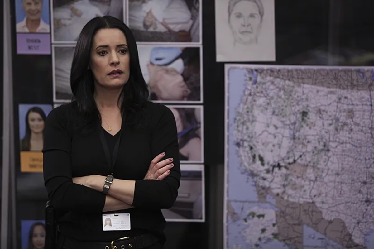 Prentiss stands with her arms crossed