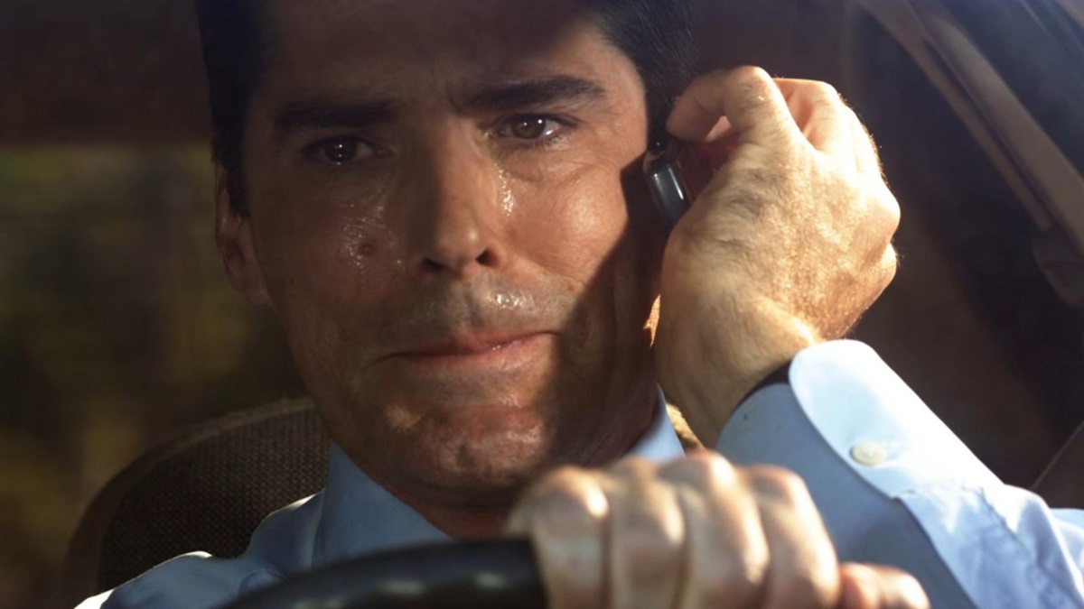 Hotch holds phone to his face and cries