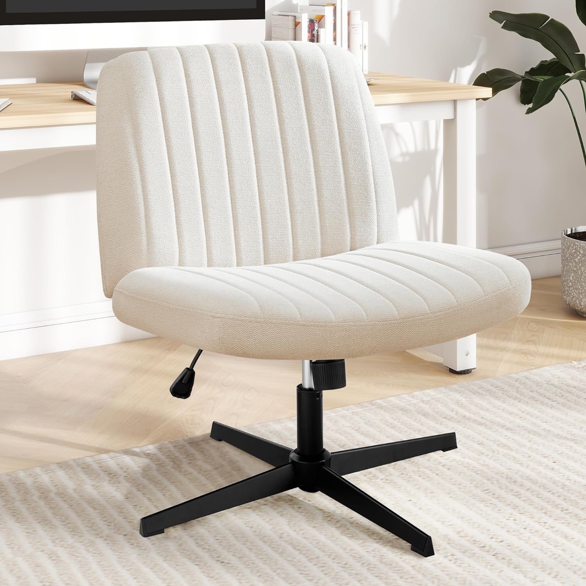 A wide white office chair in a sunlit office