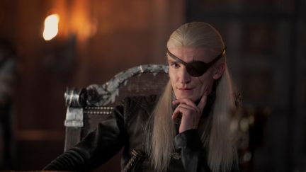 Ewan Mitchell as Prince Aemond Targaryen sits in the king's Small Council in House of the Dragon 2