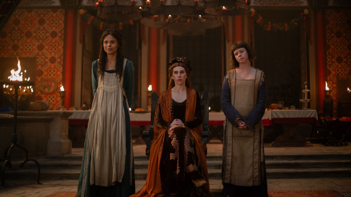 Jessica Plummer as Filomena (pretending to be Licisca) and Saoirse-Monica Jackson as Misia stand on either side of Zosia Mamet as Pampinea sitting on a chair in The Decameron