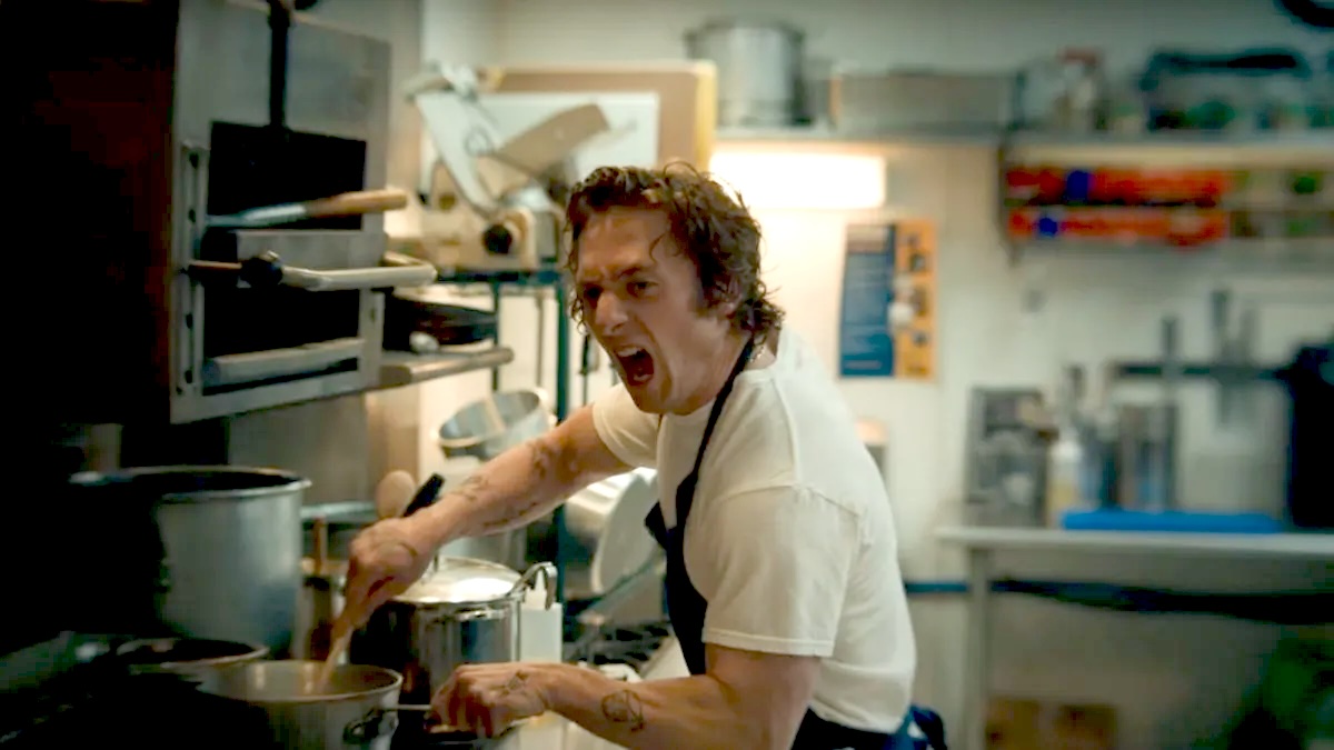 Jeremy Allen White as Carmy screams while he cooks in the kitchen on The Bear