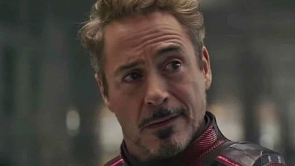 Close-up of Robert Downey Jr. as Tony Stark in a scene from 'Avengers: Endgame.' He is a white man with shaggy, light brown hair and a salt and pepper goatee. He is wearing his red Iron Man suit without the helmet and looking at someone incredulously.