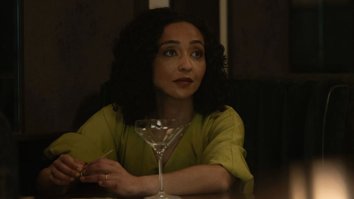 Ruth Negga as Barbara Sabich sits at a bar with a drink in Presumed Innocent