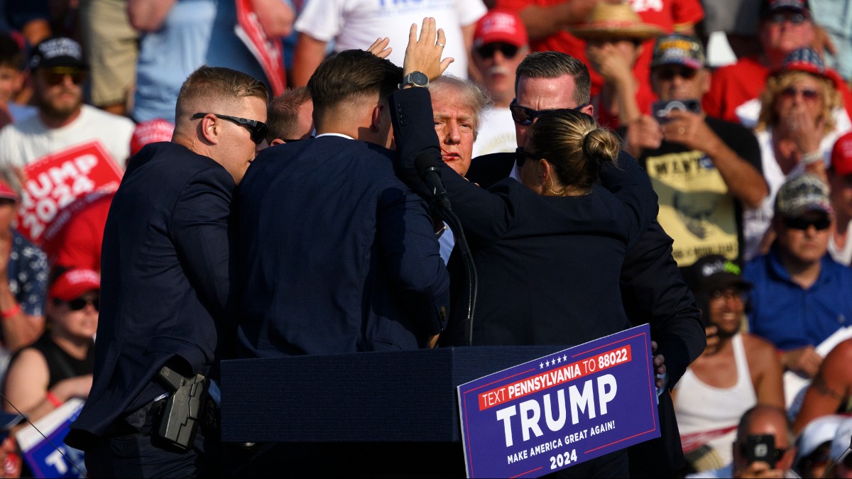 Secret Service personnel shield Donald Trump at a Trump rally