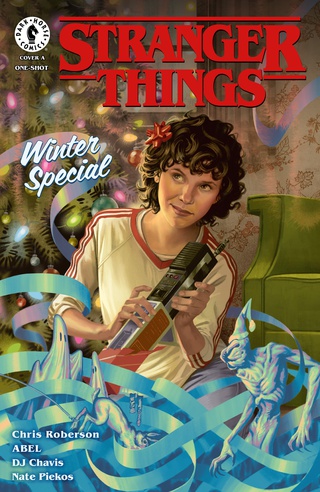 Eleven surrounded by Christmas decorations on the cover of the Stranger Things Winter Special comic book