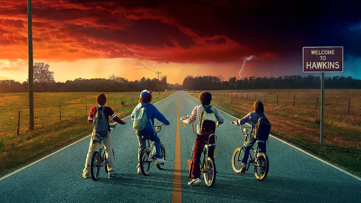 Poster for Stranger Things season 2, featuring the original four kids on their biks, staring at an ominous sky