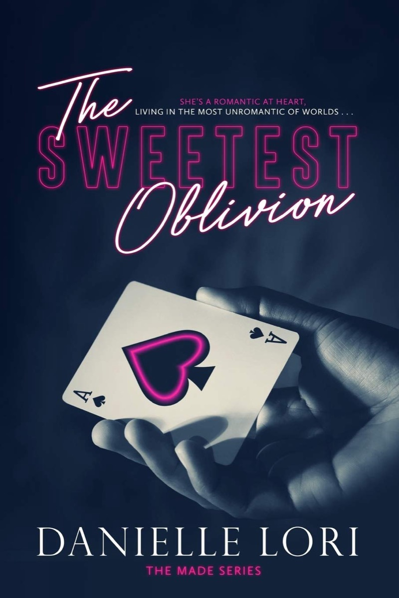 Cover art for "The Sweetest Oblivion" featuring a hand holding playing cards