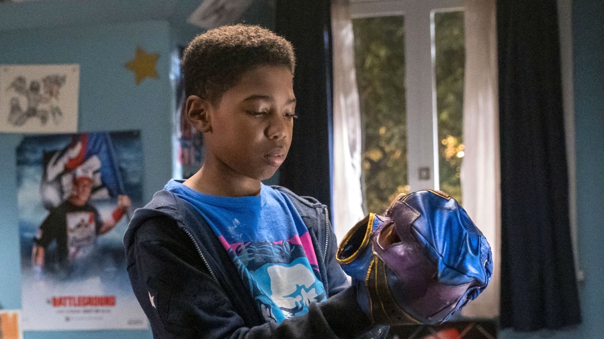 Leo (Seth Carr) examining his wrestling mask