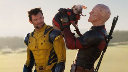 Deadpool (Ryan Reynolds) holds Dogpool next to a scowling Wolverine (Hugh Jackman) in 'Deadpool & Wolverine'