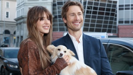 Glen Powell holding his dog with Daisy Edgar-Jones