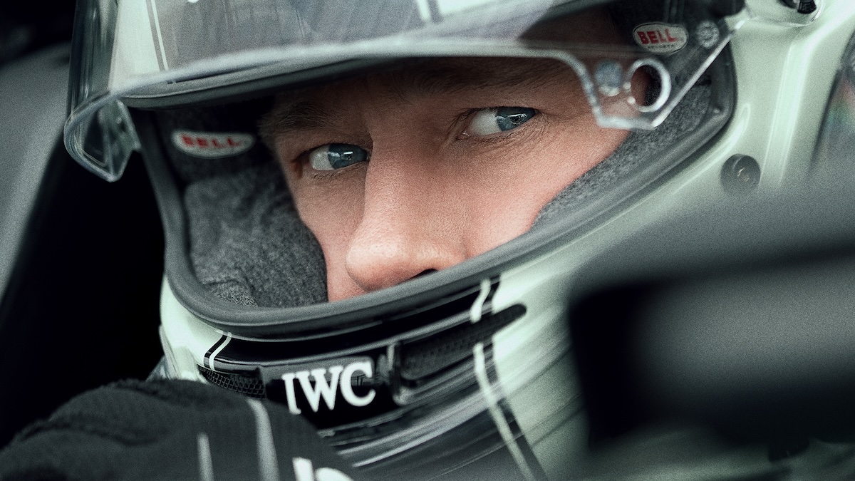 brad pitt wearing a helmet and getting ready to race