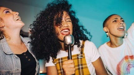 women singing karaoke together