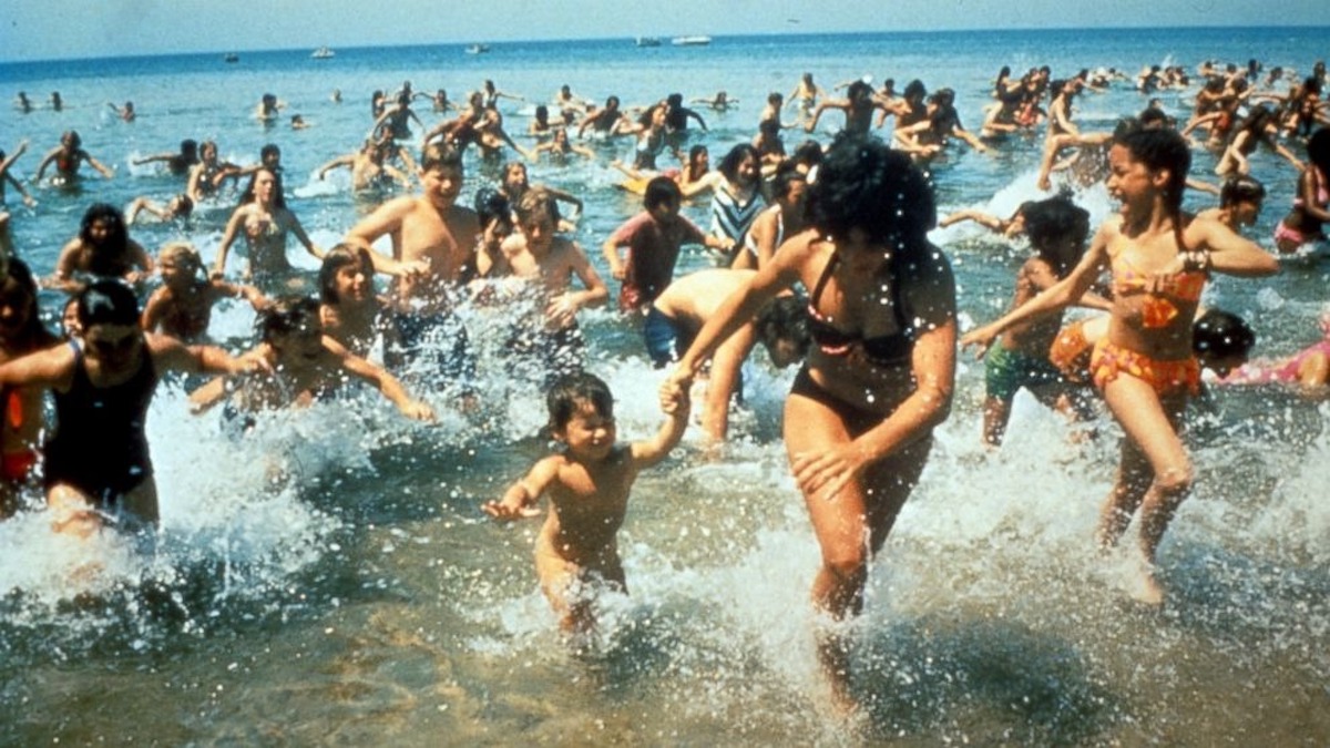 In a scene from Jaws, a crowd of beachgoers run from the water.