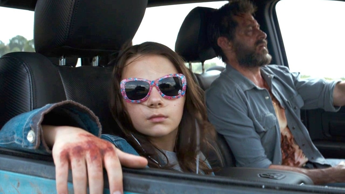 x-23 and logan sitting in a car together