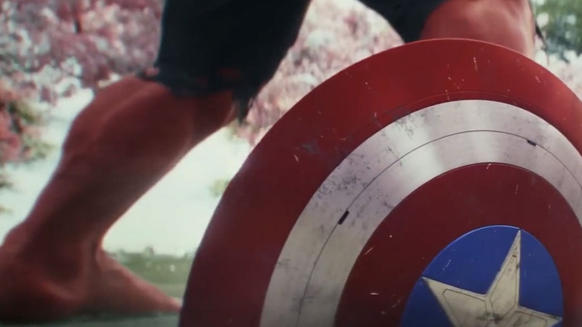 red hulk standing next to cap's shield