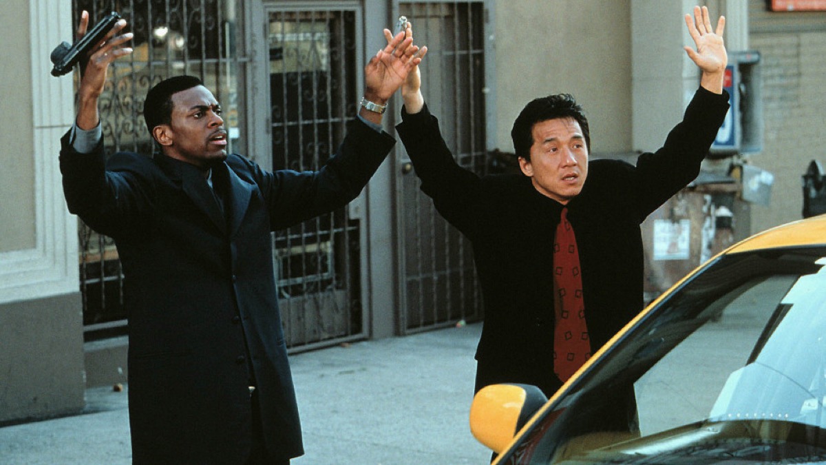 Chris Tucker and Jackie Chan hold their hands up in surrender in Rush Hour.
