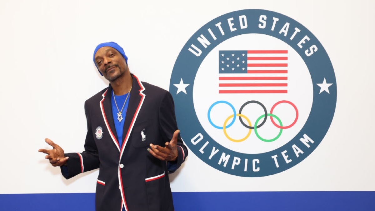Snoop Dogg in front of an Olympics logo.