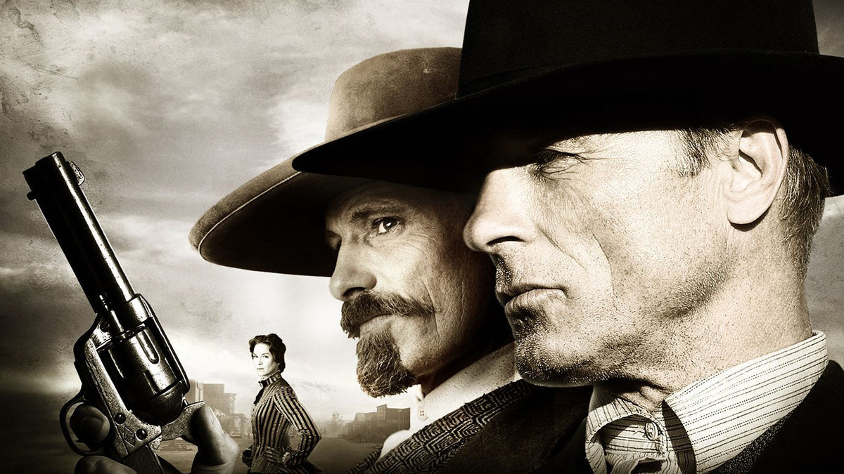 Two old lawmen hold revolvers in "Appaloosa"