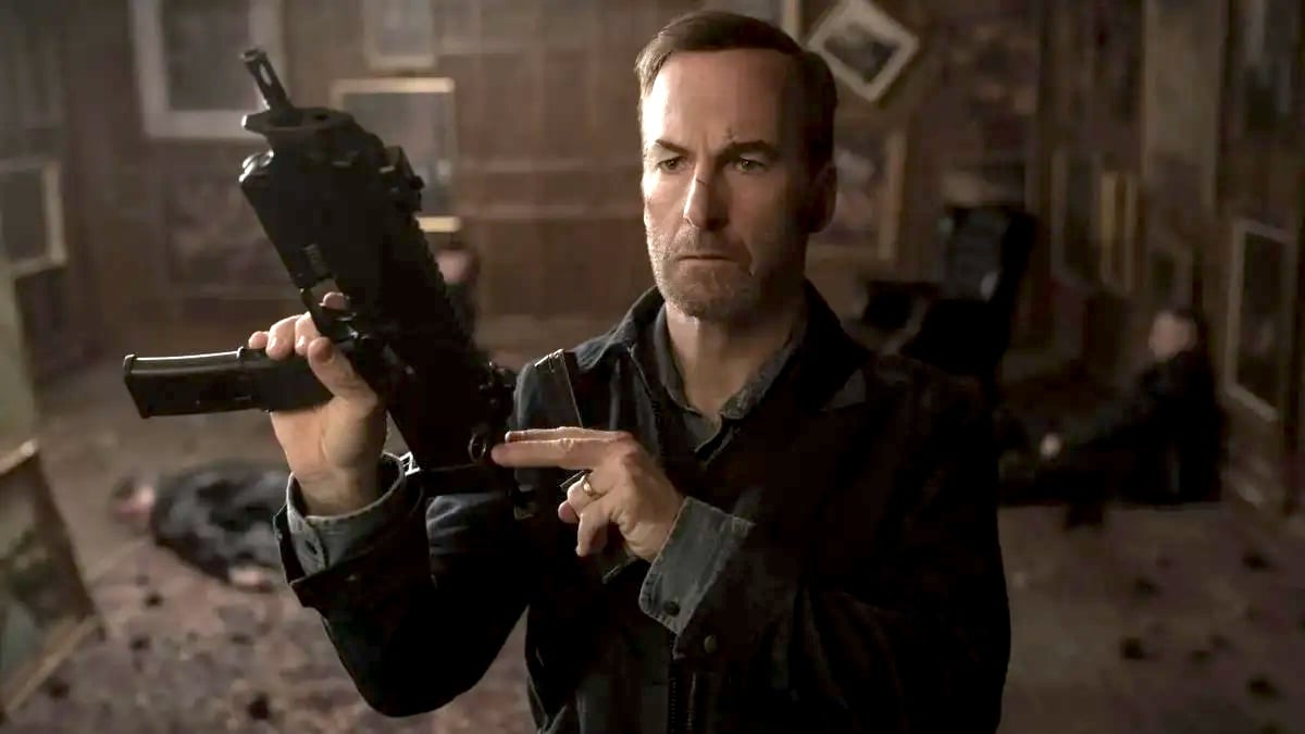 Bob Odenkirk as Hutch Mansell trots a gun in Nobody