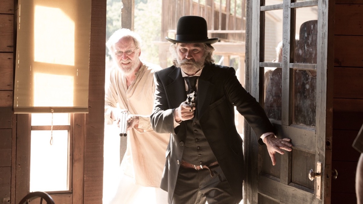 Two lawmen open a door guns drawn in "Bone Tomahawk" 