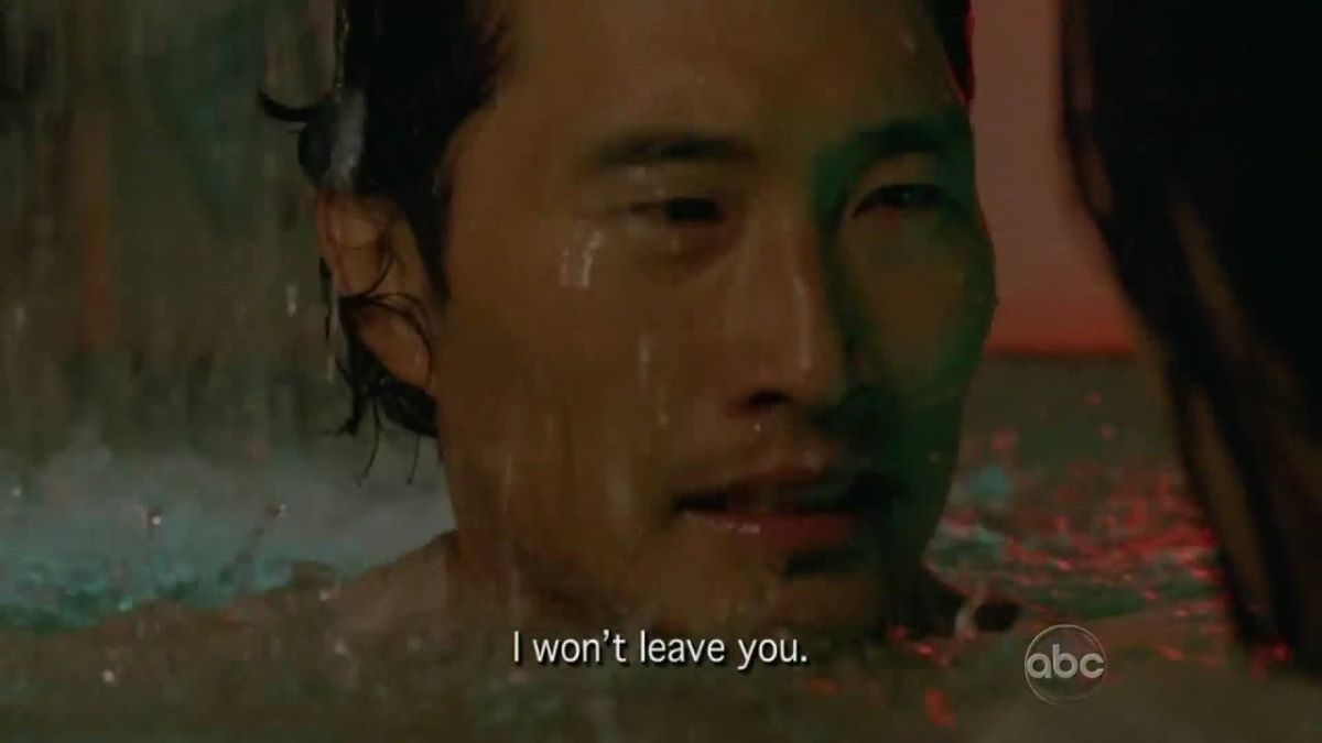 Image of Daniel Dae Kim as Jin in a scene from ABC's 'Lost.' Jin is a Korean man with shaggy dark hair. He is standing in a submarine in neck-deep water as more water pours in. He is looking at his wife. The caption at the bottom of the photo reads "I won't leave you."