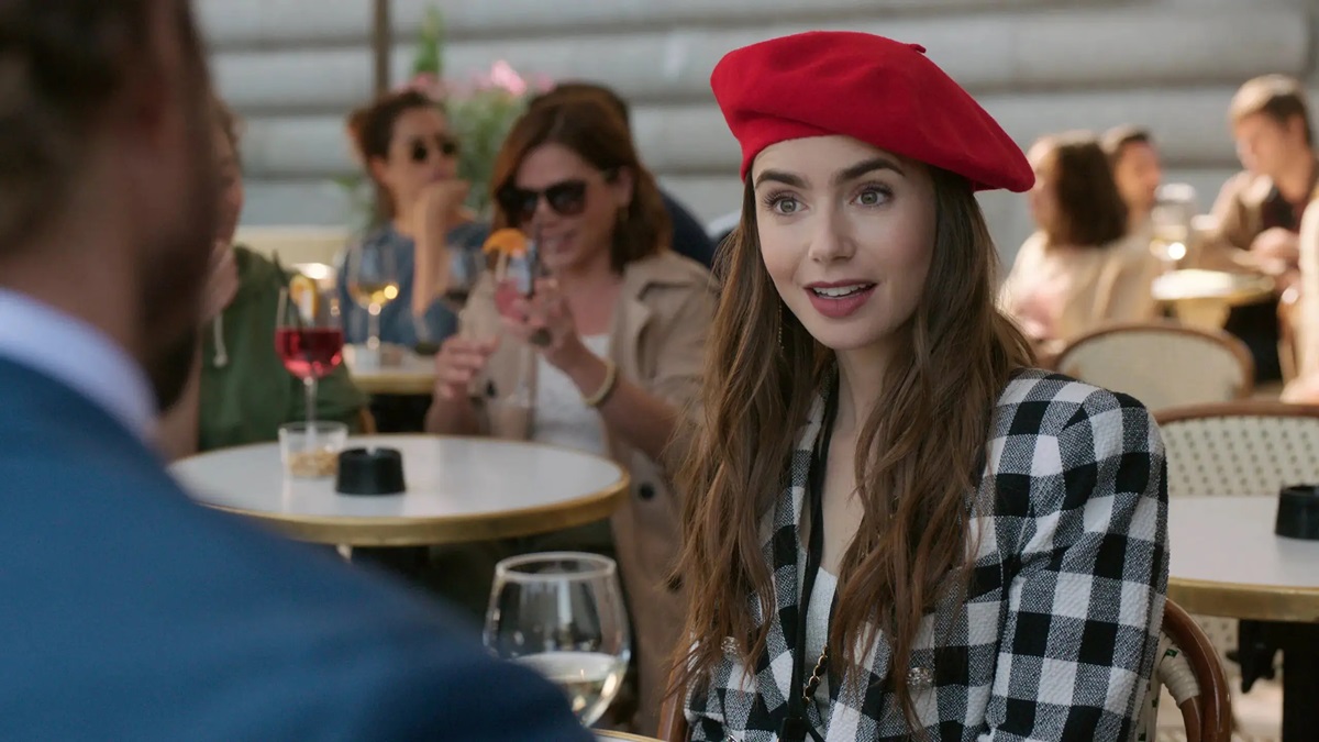 Emily wears a red beret and a surprised expression