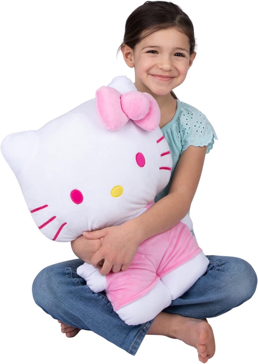 A child holds a Hello Kitty Plush