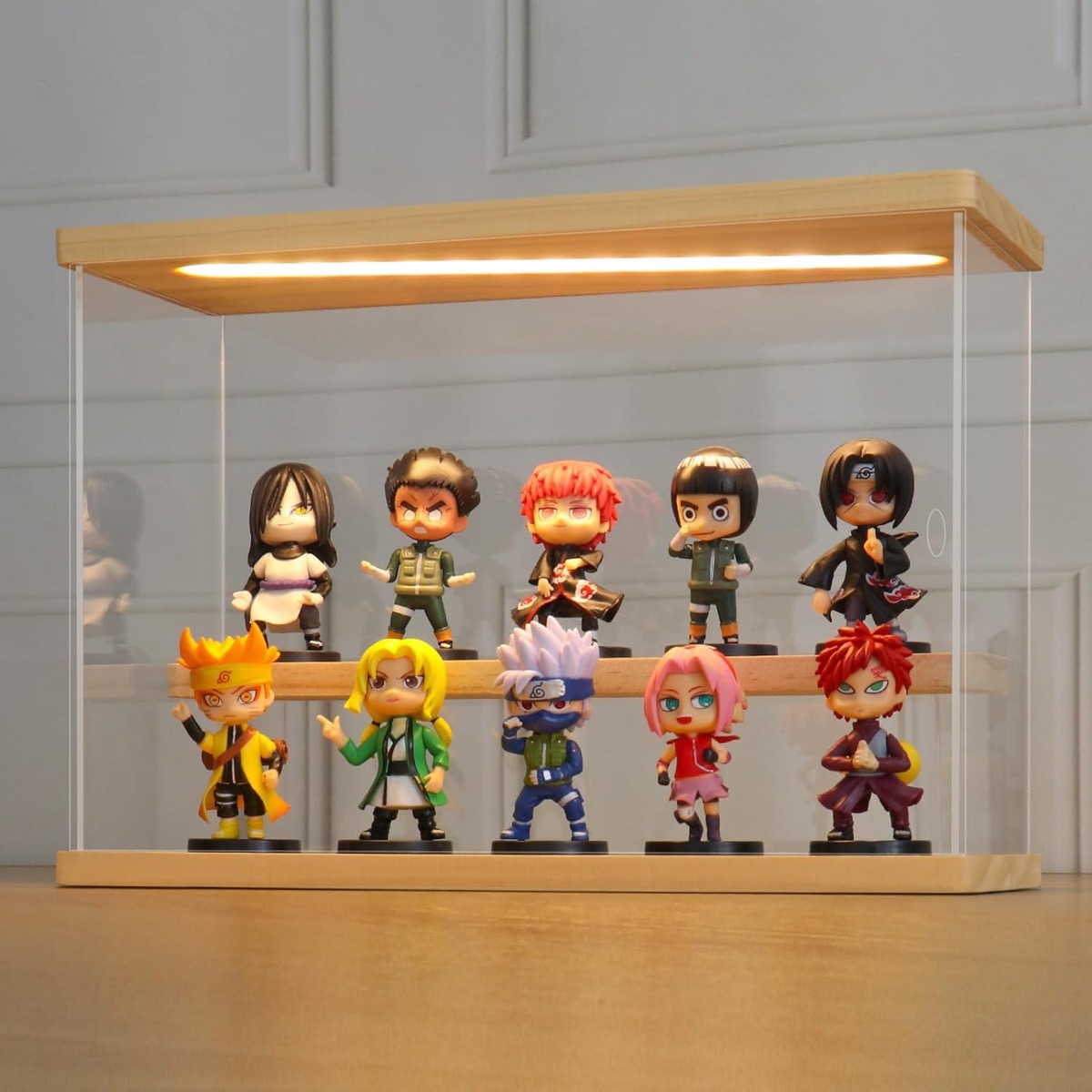 A Clear Acrylic Display Case with Light and minifigures inside 