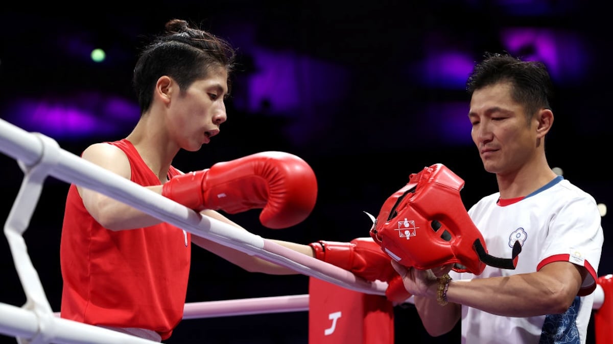 Lin Yu Ting in the Olympic boxing ring, resting against the ropes.