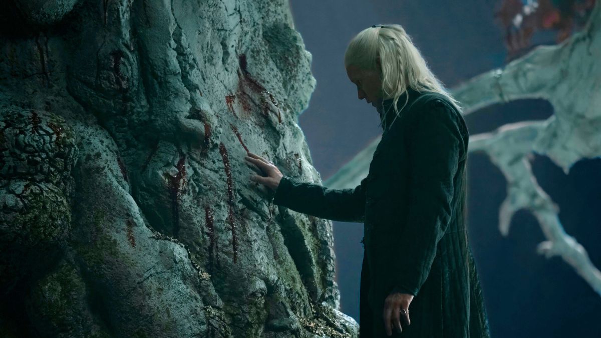 Matt Smith as Daemon Targaryen touches the weirwood heart tree at Harrenhal in House of The Dragon season 2 finale