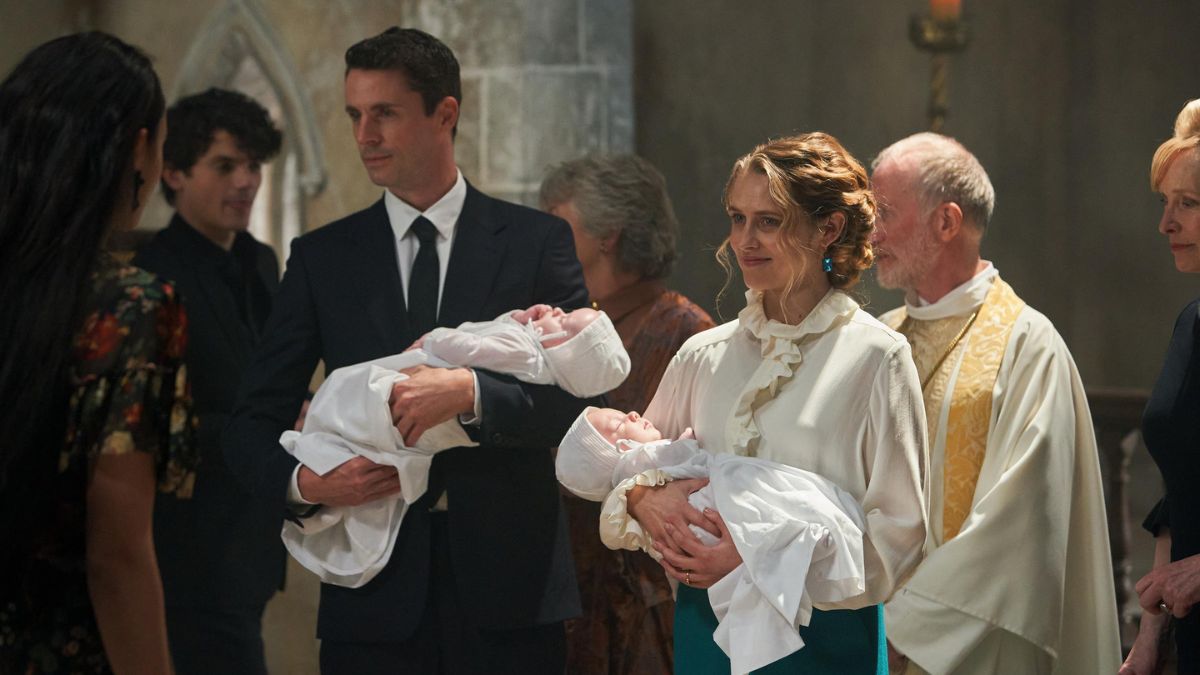 Matthew Goode as Matthew Clairmont and Teresa Palmer as Diana Bishop hold twin babies at church in A Discovery of Witches