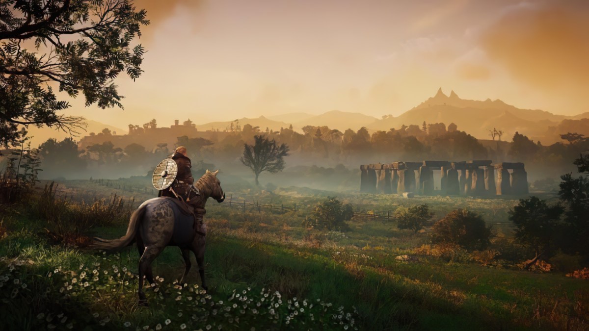 A warrior on a horse, looking towards Stonehenge in the distance in Assassin's Creed: Valhalla.