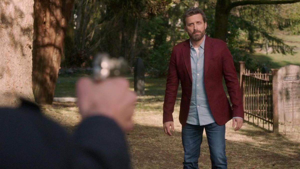 Rob Benedict as God has a gun aimed at him in Supernatural season 14