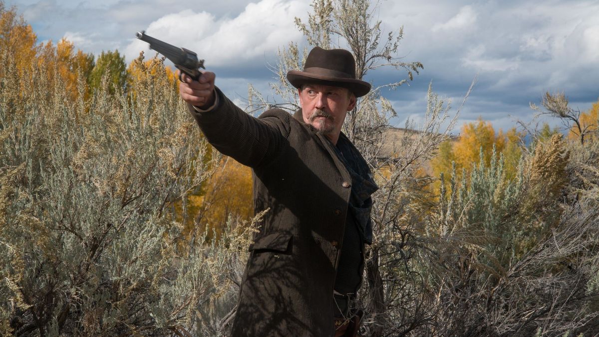 A man in a field levels a revolver at a target in "The Ballad of Lefty Brown"