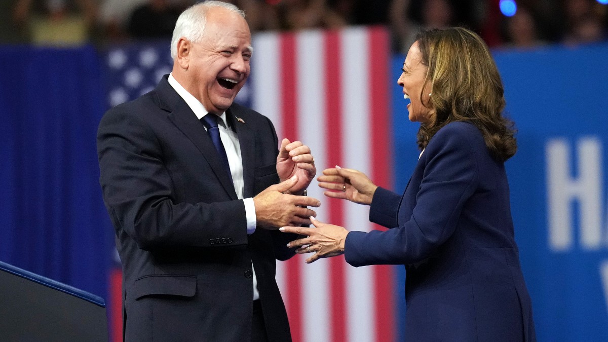 Tim Walz and Kamala Harris laughing at a rally in Philadelphia, Pennsylvania