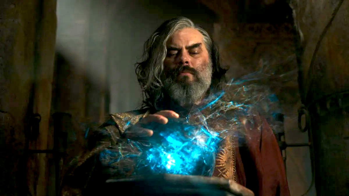 Trystan Gravelle as Chancellor Pharazôn of Númenor touches the palantír in The Rings of Power season 2