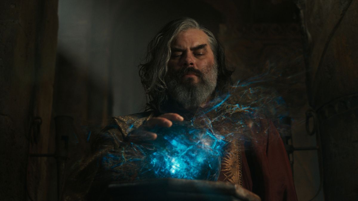 Trystan Gravelle as Chancellor Pharazôn of Númenor touches the palantír in The Rings of Power season 2