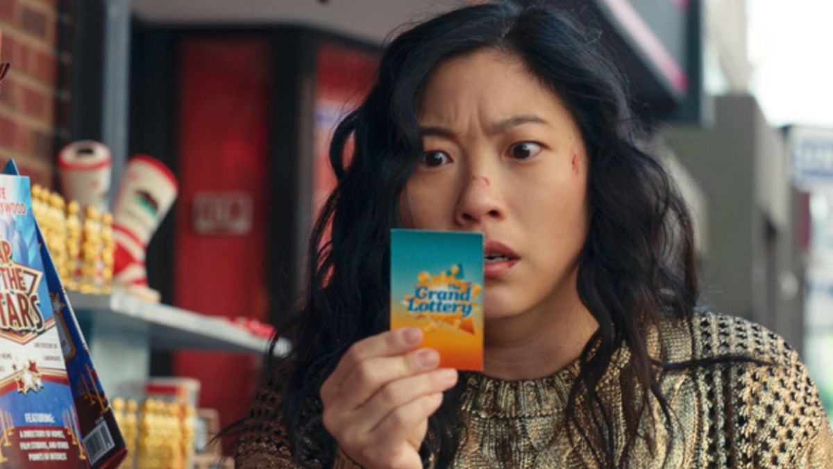 Katie Kim (Awkwafina) holds a winning lottery ticket in 'Jackpot'