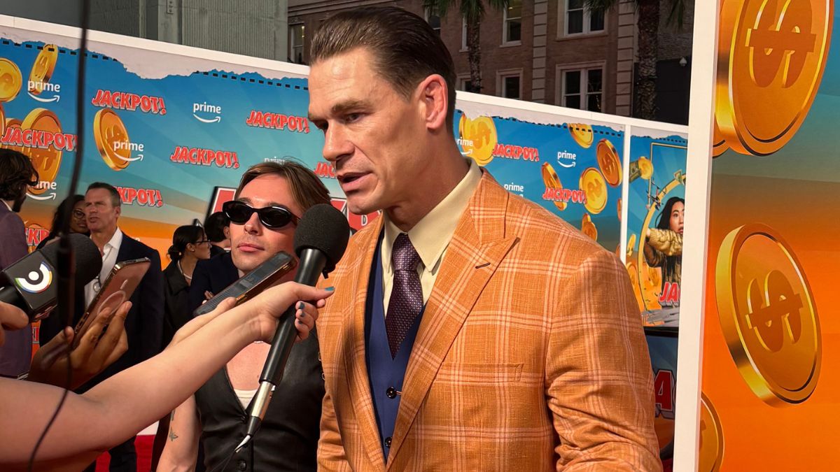 John Cena talks into a microphone at the rec carpet world premiere of 'Jackpot'