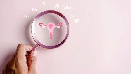 A uterus under a magnifying glass with healthcare symbols