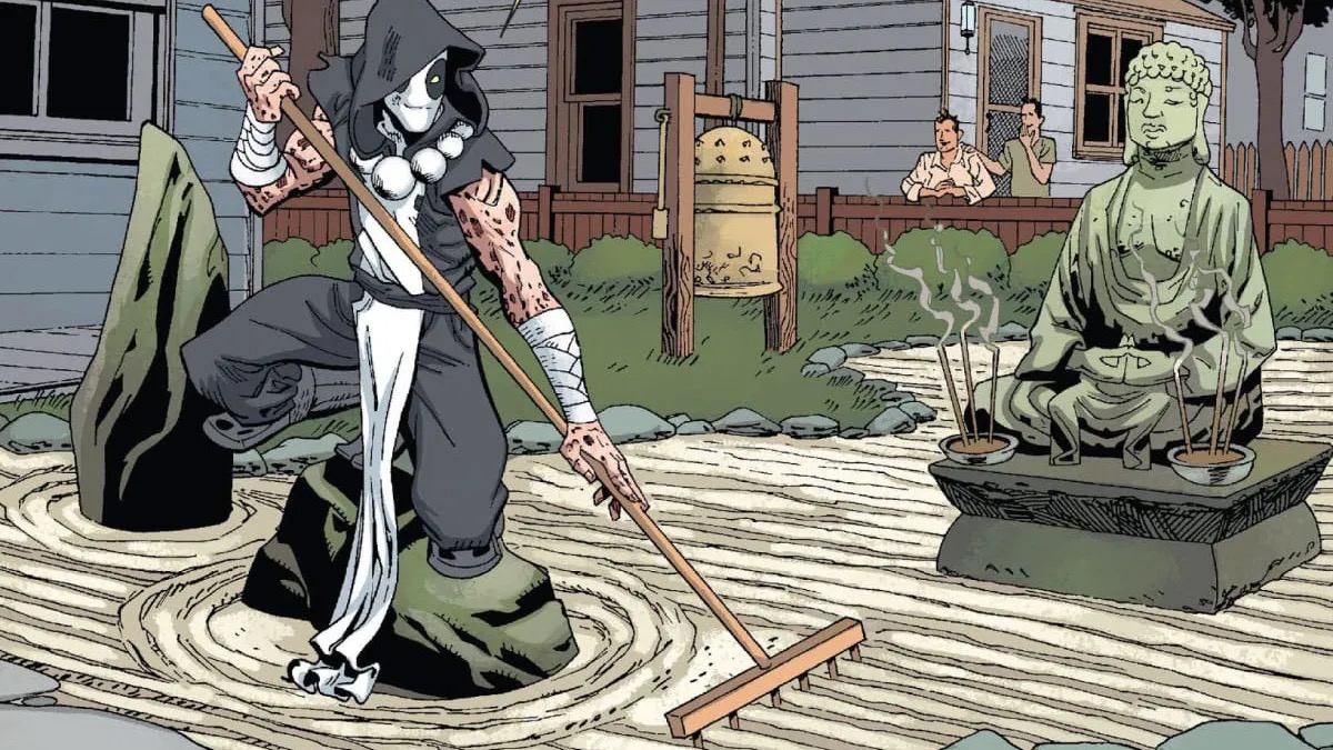 A white suited Deadpool rakes sand in a Zen garden