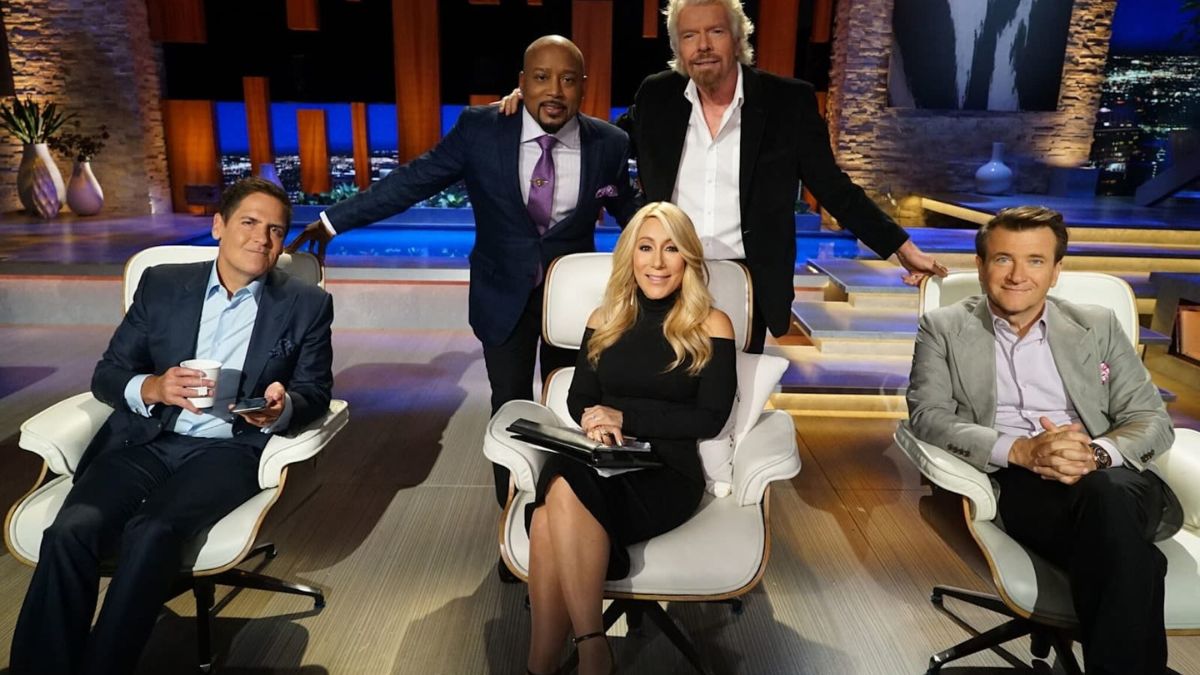 The cast of Shark Tank posing with Richard Branson