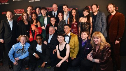 The cast of Stranger Things: The First Shadow posing for pictures.