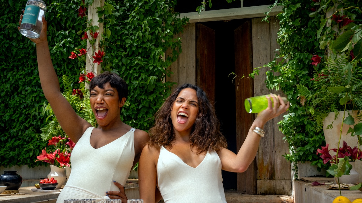 adria arjona and naomi ackie mixing drinks together