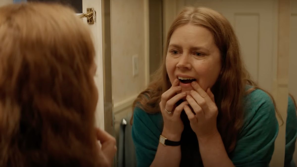 Amy Adams examines her teeth in the trailer for Nightbitch