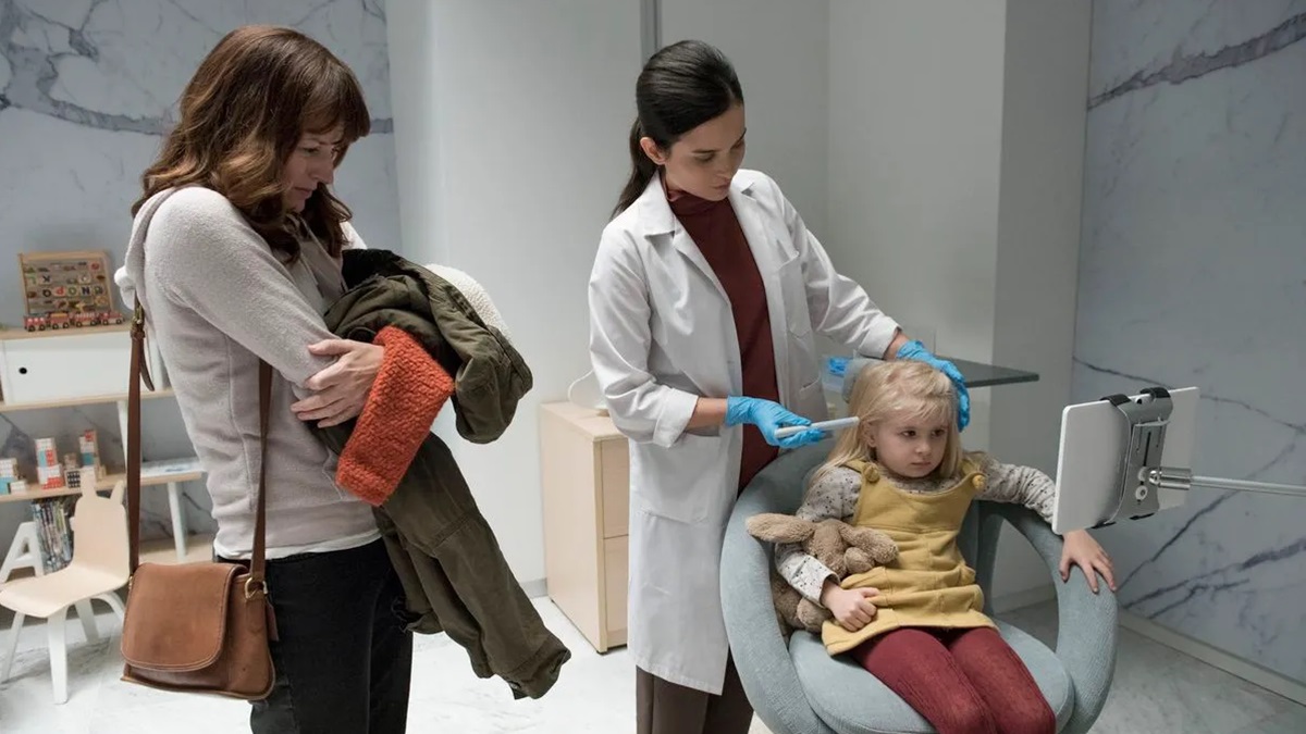 mom watches while doctor injects little girl with serum